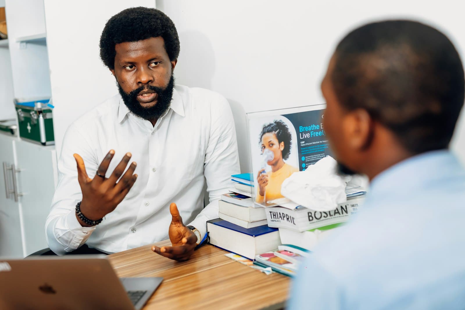 An advisor at his desk talking a student through his options