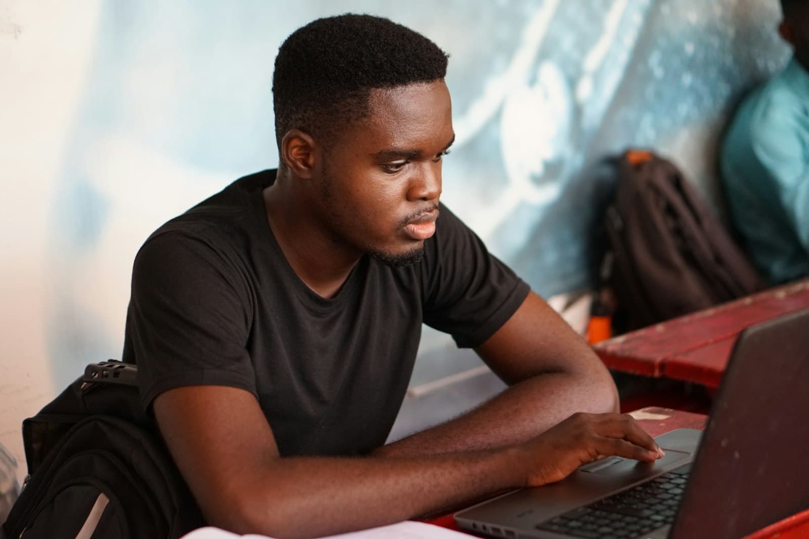 A student checking his modules on a laptop